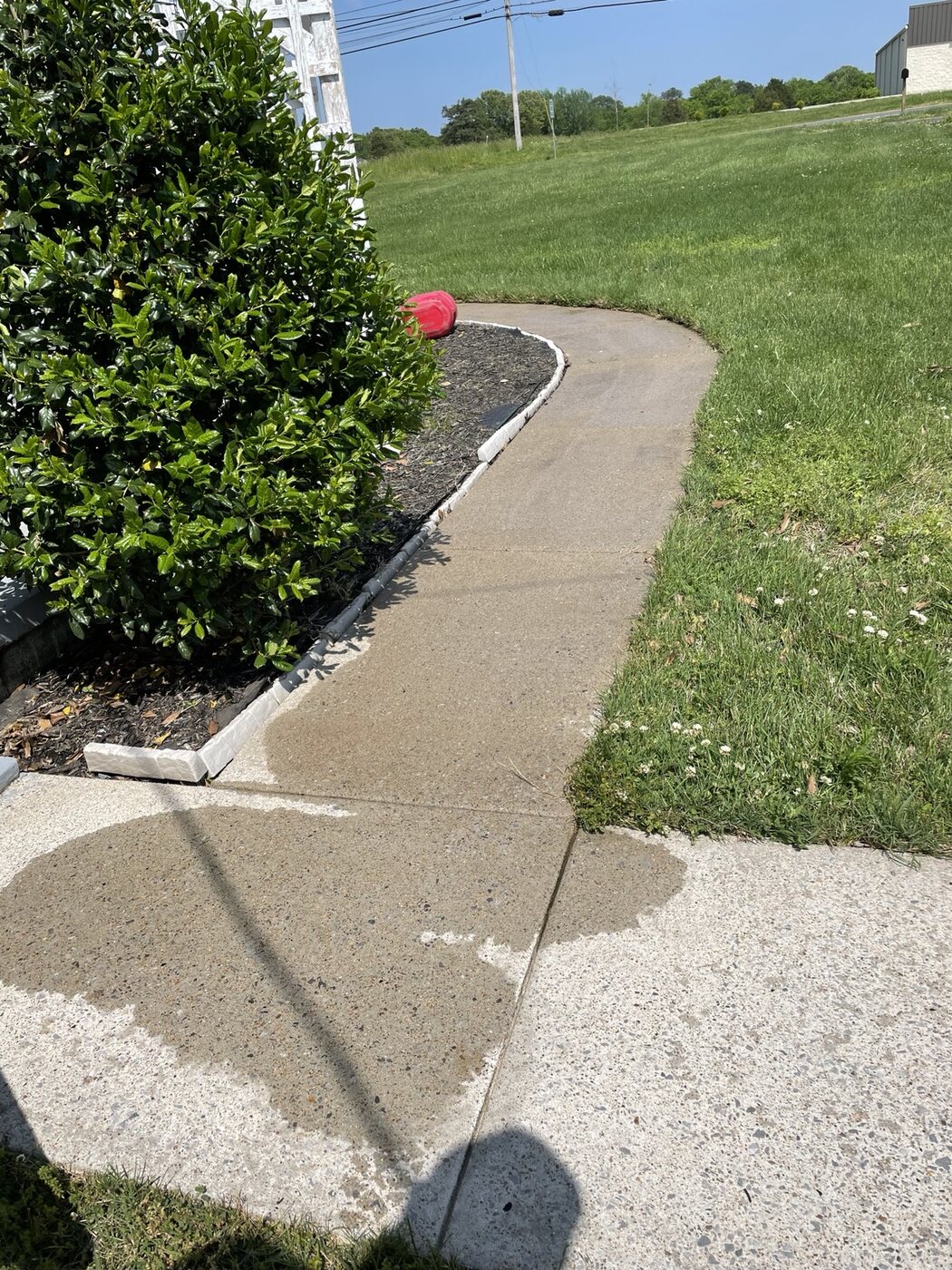 Clean concrete walkway after pressure washing by Anderson Home Services