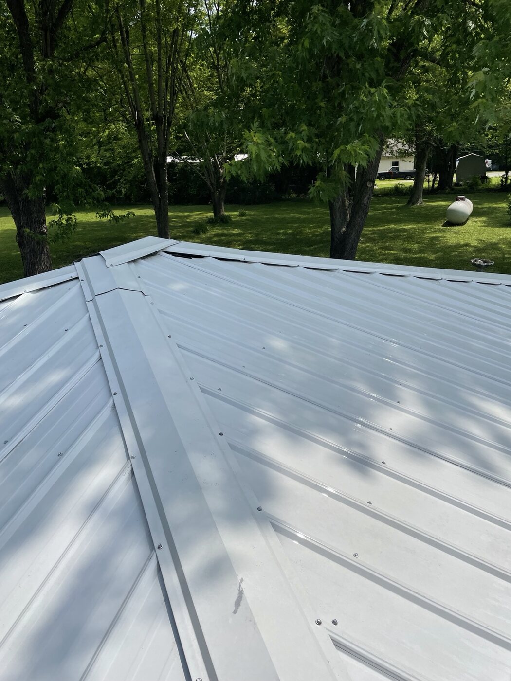 Bright clean metal roof after washing by Anderson Home Services