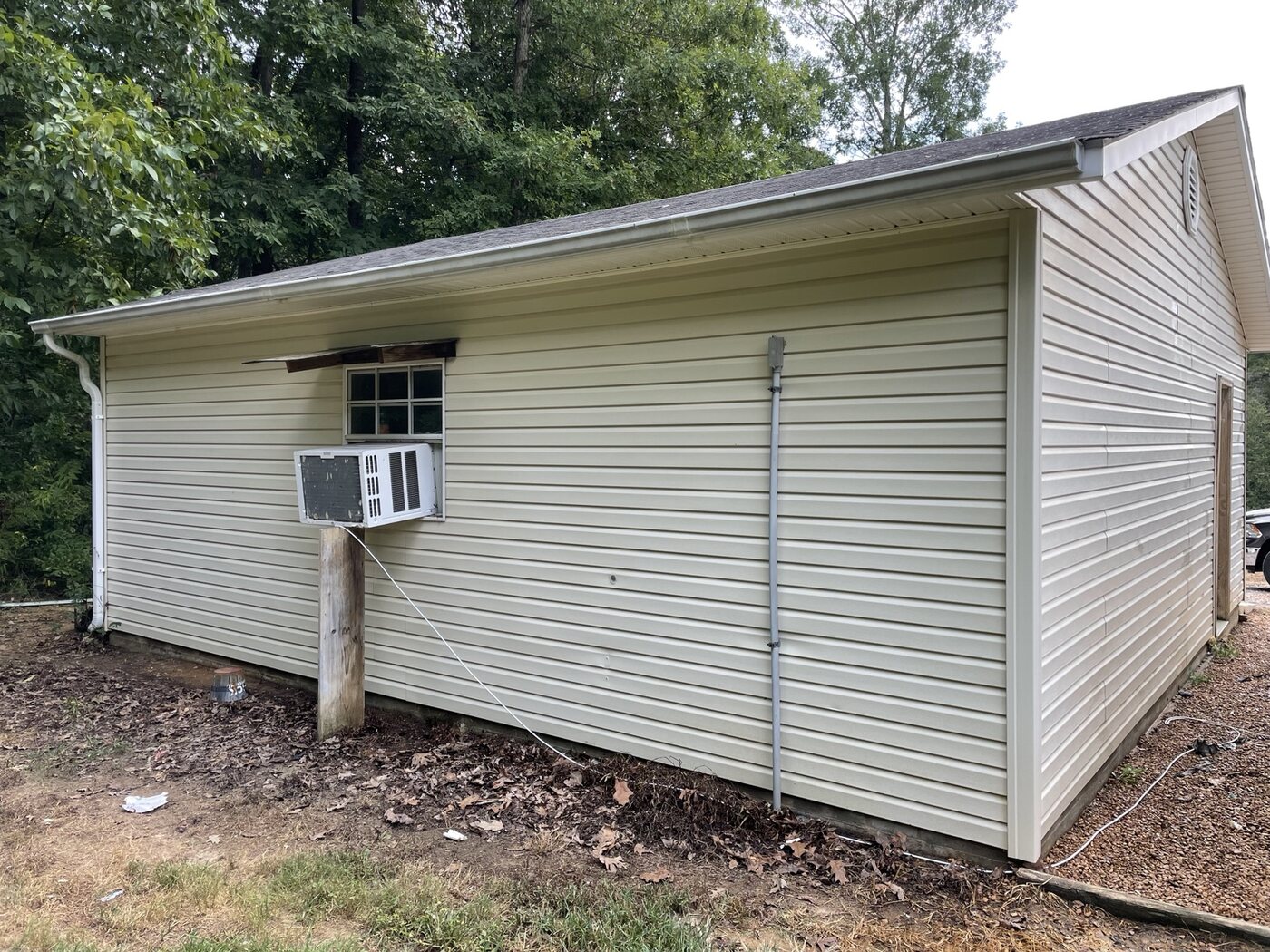 Clean garage siding after soft washing by Anderson Home Services